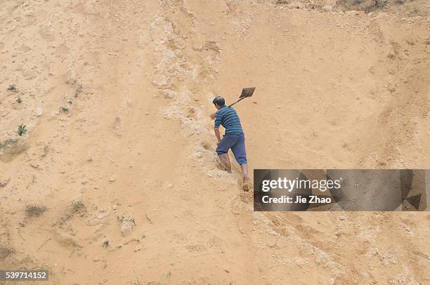 Man works at the site of a rare earth metals mine at Nancheng county, Jiangxi province October 20, 2010. China on Wednesday denied a report that the...