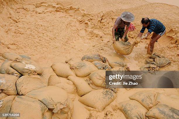Labourers work at the site of a rare earth metals mine at Nancheng county, Jiangxi province October 20, 2010. China on Wednesday denied a report that...