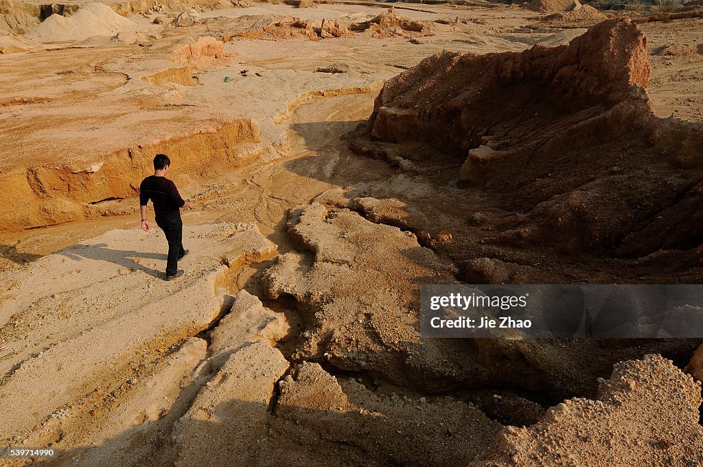 A labourer works at the site of a rare earth metals mine at Nancheng county