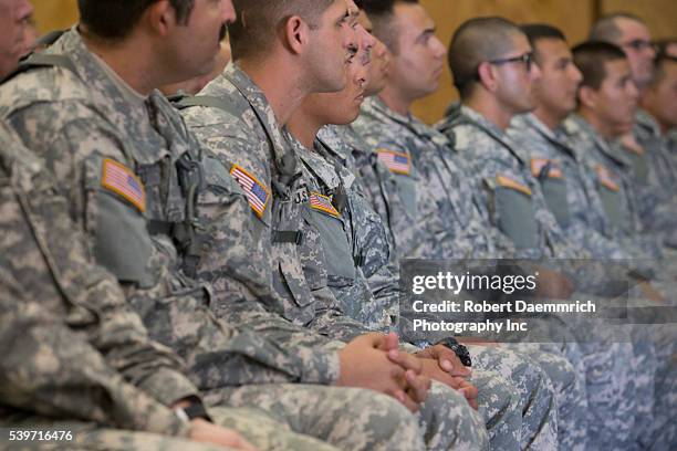 National Guard members listen to Texas Governor Rick Perry speak as he tours Texas Guard operations at Camp Swift east of Austin as troops prepare...