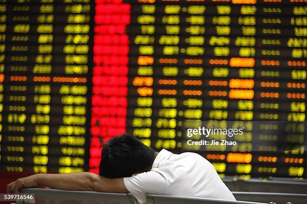 An investor watches the eclectic monitor at a stock exchange in Huaibei, Anhui province, China on 25th August 2015. China's stock market index has...