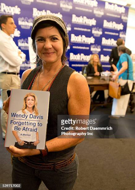 Texas Democratic gubernatorial candidate Senator Wendy Davis supporters show off their copies of book "Forgetting to be Afraid" at Book People...