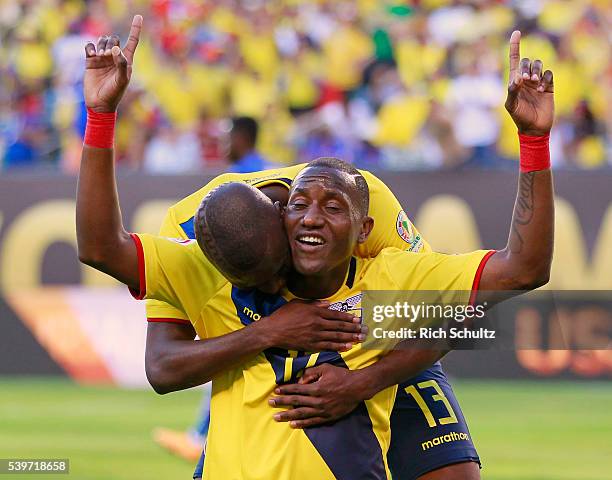 Jaime Ayovi of Ecuador celebrates with teammate Enner Valencia after scoring the second goal of his team during a group B match between Ecuador and...