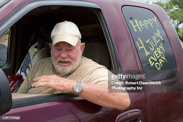 Militia member and landowner Rusty Monsees, Jr. Of Brownsville, Texas sits in his pickup next to his land by the border wall in south Texas. Monsees...