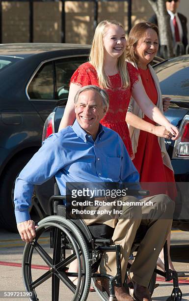 Republican front-runner for Texas governor Greg Abbott leaves an early voting site with his wife Ceclia and daughter Audrey after casting ballots...