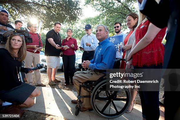 Republican front-runner for Texas governor, Greg Abbott speaks to the press after casting his ballot in early voting ahead of next week's election....