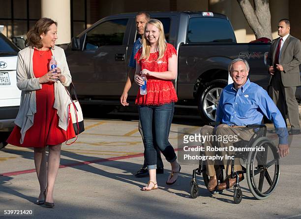 Republican front-runner for Texas governor Greg Abbott leaves an early voting site with his wife Ceclia and daughter Audrey after casting ballots...