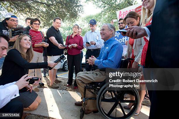Republican front-runner for Texas governor, Greg Abbott speaks to the press after casting his ballot in early voting ahead of next week's election....
