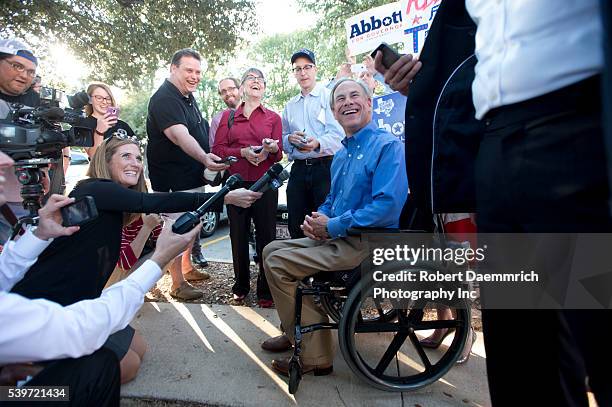 Republican front-runner for Texas governor, Greg Abbott speaks to the press after casting his ballot in early voting ahead of next week's election....