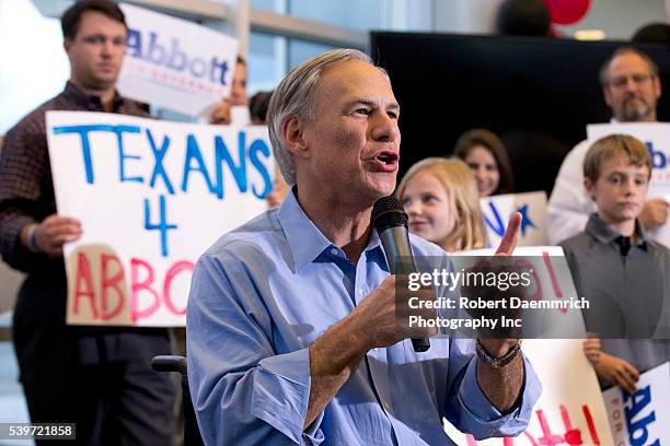 Texas governor candidate Greg Abbott arrives to address cheering supporters at an executive aviation terminal after campaigning state wide on the eve...