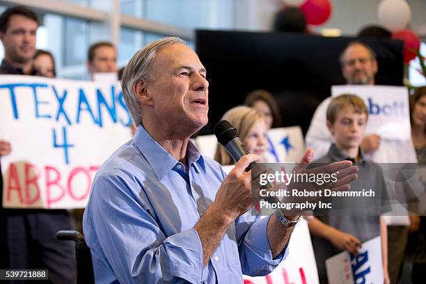 Texas governor candidate Greg Abbott arrives to address cheering supporters at an executive aviation terminal after campaigning state wide on the eve...