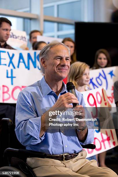 Texas governor candidate Greg Abbott arrives to address cheering supporters at an executive aviation terminal after campaigning state wide on the eve...