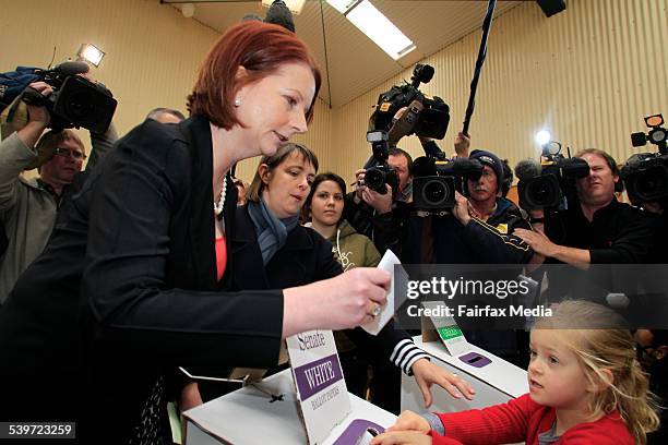 Federal Election. Prime Minister Julia Gillard casts her vote with the assistance of Nicola Roxon's daughter, Rebecca, at Seabrook in Melbourne's...