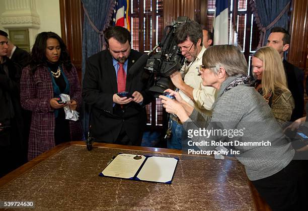 February 2nd, 2015 Austin, Texas USA: Members of the media take photos and video of proclamation signed by Texas Governor Greg Abbott as February...