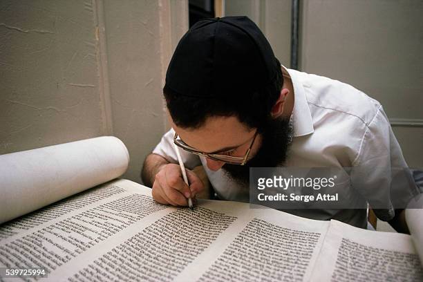 Scribe copies the Torah by hand.