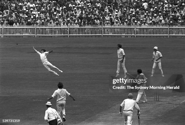 Australian fieldsman Greg Chappell dives and deflects a chance from World XI batsman Farokh Engineer off the bowling of Dennis Lillee during the...