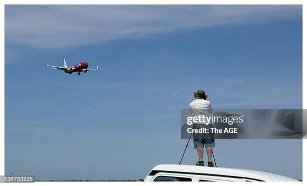 Plane spotters watch a Virgin Airlines 737-800 at Melbourne Airport, on 14 November 2005. THE AGE NEWS Picture by CRAIG ABRAHAM
