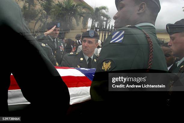 Soldiers lift the casket as over 1,000 friends and family attend funeral services for Army Sgt. Edmond Randle Jr, who was killed in the Iraq War. The...