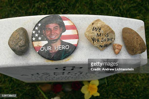 Mementos left by friends and family at the grave of Captain James Adamouski, a West Point graduate of 1995 who was killed in Iraq. The day before...