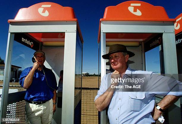 Minister for Communication, Senator Richard Alston in makes an untimed local call at a phone booth in Birdsville, Queensland, to Senator Ron Boswell...