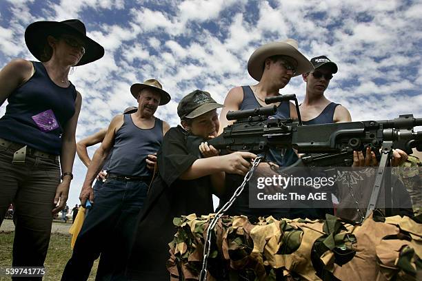 Boy tests out weapons on display provided by the Australian Army at the Deniliquin ute muster, 1 October 2005. THE AGE Picture by ANGELA WYLIE