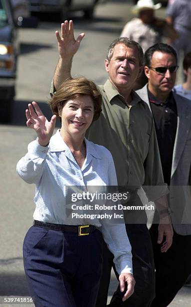 George and Laura Bush, with heavy security, walk the route of the Bell County Independence Day Parade in downtown Belton, Texas.