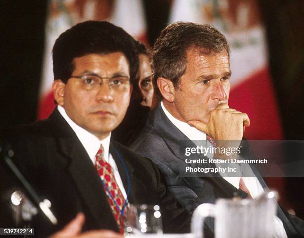 Texas Secretary of State Alberto Gonzales sits with Governor George W. Bush at the Borders Governors Conference in Brownsville, Texas.