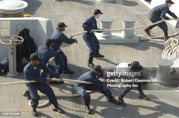 Navy line handlers work the ropes securing the ship to the Ingleside ...