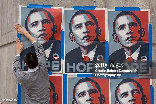Supporter of Democratic presidential hopeful Barack Obama pastes up posters outside the Rec Sports Center at the Univeristy of Texas at Austin hours...