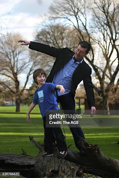 Red Symons, who quit smoking one year ago, plays in a Melbourne park with his son, Joel, 28 July 2005. The Age Picture by NIC KOCHER