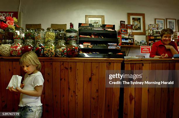Chelsey Frohling sorts through her bag of mixed lollies, a Thursday afternoon ritual, at the Burrumbuttock general store which is also the post...