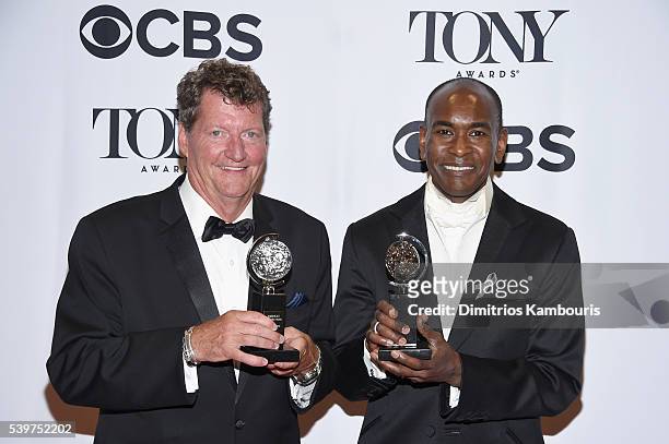 Lighting designer Howell Binkley and costume designer Paul Tazewell pose with awards during the 70th Annual Tony Awards at The Beacon Theatre on June...