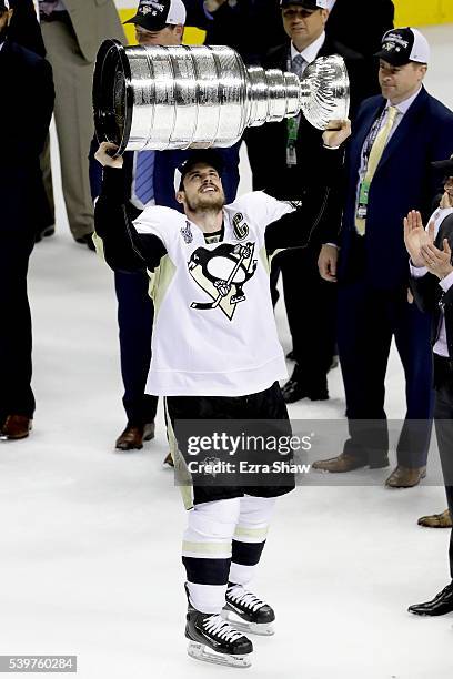 Sidney Crosby of the Pittsburgh Penguins celebrates by hoisting the Stanley Cup after their 3-1 victory to win the Stanley Cup against the San Jose...