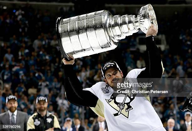 Sidney Crosby of the Pittsburgh Penguins celebrates by hoisting the Stanley Cup after their 3-1 victory to win the Stanley Cup against the San Jose...