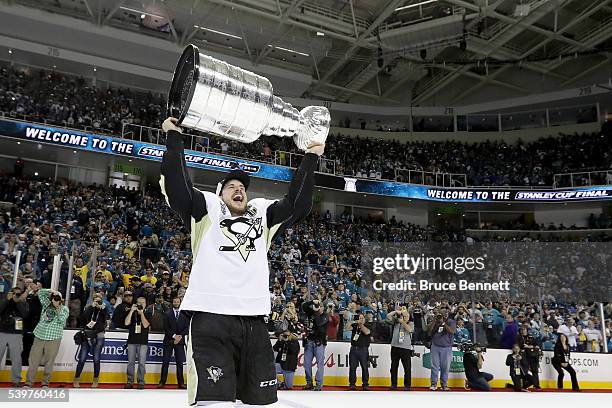 Sidney Crosby of the Pittsburgh Penguins celebrates by hoisting the Stanley Cup after their 3-1 victory to win the Stanley Cup against the San Jose...