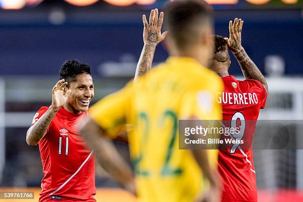 Raúl Ruidíaz of Peru celebrates with teammate Paolo Guerrero after winning a group B match between Brazil and Peru at Gillette Stadium as part of...