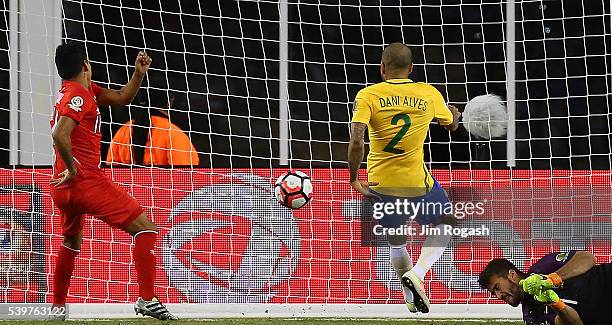 Raul Ruidiaz of Peru scores despite the defense of Daniel Alves of Brazil and Alisson Becker in the second half during the 2016 Copa America...