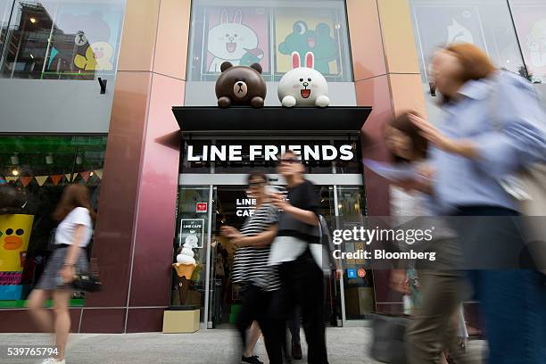 Pedestrians walk past a Line Friends flagship store, operated by Line Corp., a subsidiary of Naver Corp., in the Itaewon district in Seoul, South...