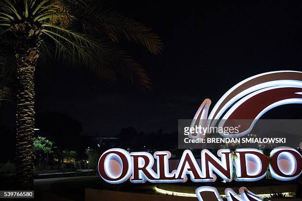 Flowers are left on a sign at the Orlando Regional Medical Center near the Pulse nightclub on June 12, 2016 in Orlando, Florida. People close to the...