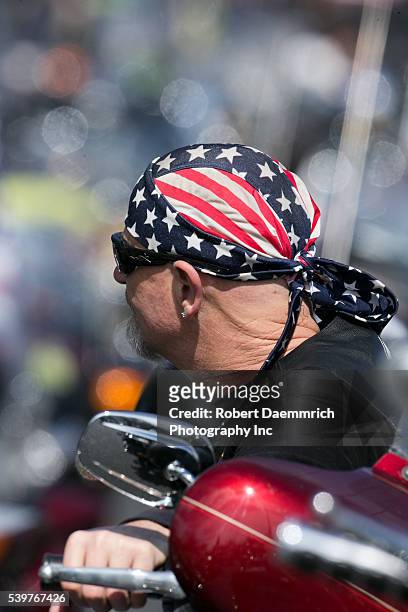 Member of the Patriot Guard motorcycle escort team waits as Navy SEAL Chris Kyle is laid to rest at the Texas State Cemetery as the sniper credited...