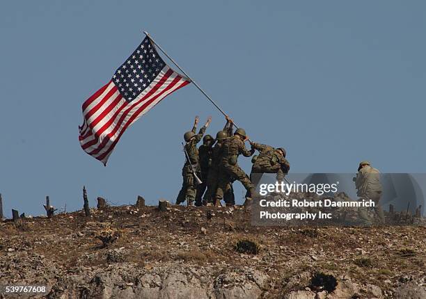 Marines re-enact the flag-raising on Iwo Jima at a large ranch in Doss, Texas, to commemorate the 60th anniversary of the battle for the south...