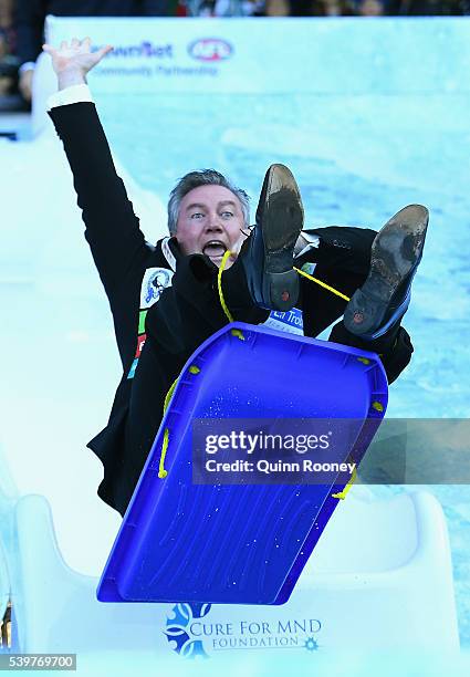 Eddie McGuire goes down the slide for Freeze MND during the round 12 AFL match between the Melbourne Demons and the Collingwood Magpies at Melbourne...