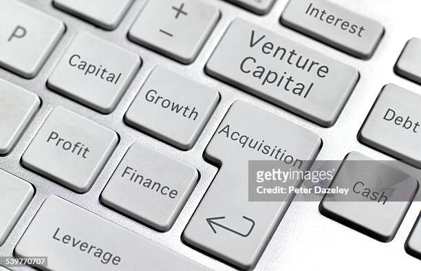 venture capital keyboard - merger foto e immagini stock