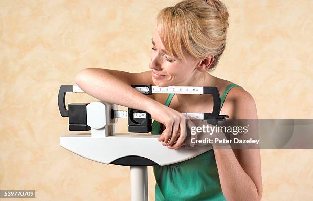 unhappy dieter - balancing scale stock pictures, royalty-free photos & images