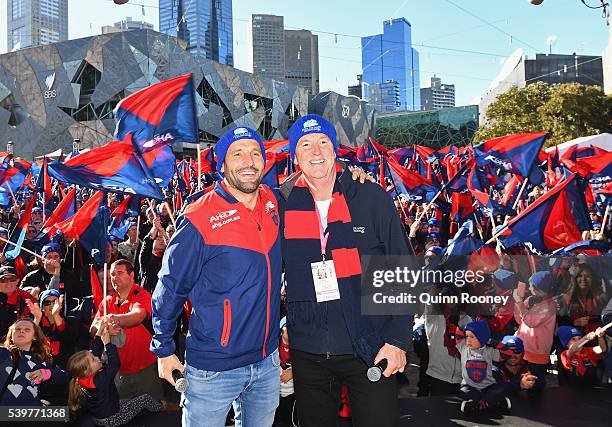 Russell Robertson and Neale Daniherpose at Federation Square before walking to the MCG during the round 12 AFL match between the Melbourne Demons and...