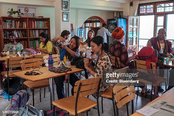 Tourist takes a selfie photograph at a restaurant in the McLeod Ganj area of Dharamsala, India, on Saturday, June 4, 2016. Consumer Price Index...