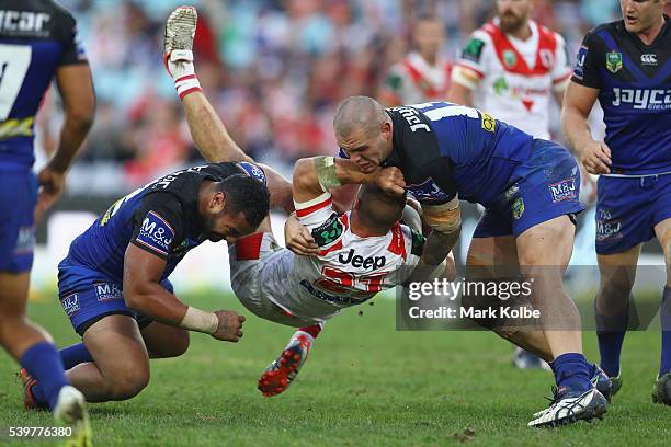 Raymond Faitala and David Klemmer of the Bulldogs tackle Jack De Belin of the Dragons during the round 14 NRL match between the St George Illawarra...