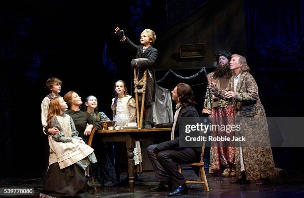 Tommy Steele , Laurence Belcher and members of the cast in the production Scrooge at the London Palladium.