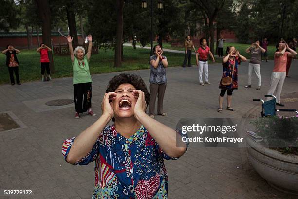 Chinese women shout as they do voice exercises at Ritan Park on June 12, 2016 in Beijing, China. Ritan, meaning 'sun altar', is among the oldest...