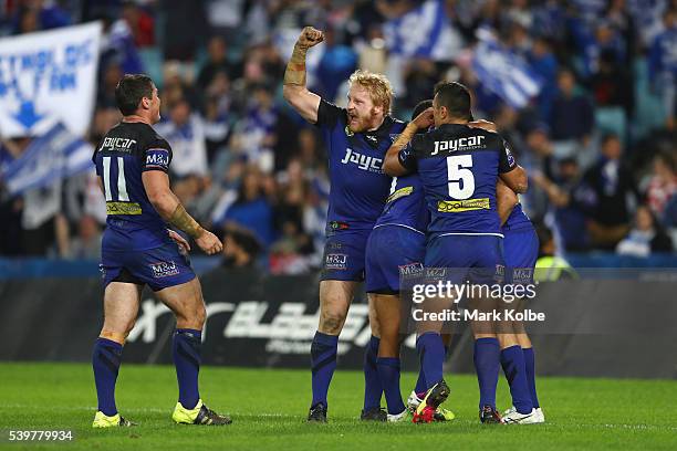 James Graham of the Bulldogs celebrates as the Bulldogs players congratulate Josh Reynolds of the Bulldogs after he scored a try during the round 14...